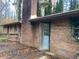 Brick house exterior with wooden deck and surrounding trees at 3955 Demooney Rd, Atlanta, GA 30349