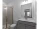 Clean bathroom with a walk-in shower, gray vanity, and a toilet at 4231 Baden Aly, Duluth, GA 30097