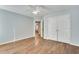 Bedroom with hardwood floors, ceiling fan, and double doors to closet at 1113 Blackshear Dr, Decatur, GA 30033