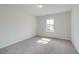 Bright bedroom with carpeted floors and a large window at 173 Haverling Pass, Hampton, GA 30228