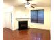 Living room featuring hardwood floors, fireplace, and ceiling fan at 5625 Terremont Cir, Norcross, GA 30093