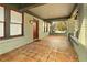 Spacious front porch with terracotta tile flooring and a red front door at 1524 S Gordon Sw St, Atlanta, GA 30310