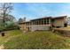 Back of house, showcasing a large yard and screened porch at 240 Thornton Dr, Fayetteville, GA 30214