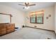 Bedroom with dresser, window, and ceiling fan at 4240 Stilesboro Nw Rd, Kennesaw, GA 30152