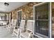 Front porch with rocking chairs and stonework at 4240 Stilesboro Nw Rd, Kennesaw, GA 30152