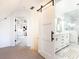 Elegant bathroom with marble floors and a barn door at 944 Northern Se Ave, Atlanta, GA 30316