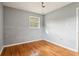 Simple bedroom with hardwood floors and a window at 1190 Crestview Ne Cir, Conyers, GA 30012