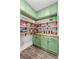 Bright walk-in pantry featuring wood shelves and green cabinetry at 4878 Golden Finch Ln, Powder Springs, GA 30127