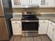 Stainless steel range and overhead vent hood in kitchen at 2170 Golden Dawn Sw Dr, Atlanta, GA 30311