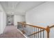 Upstairs hallway with carpeted floors and wooden railing at 4006 Cherry Wood Dr, Loganville, GA 30052