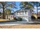 Gray siding house with a red front door and a long driveway at 5426 Radford Ln, Lithonia, GA 30038