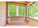 Porch with wooden swing and view of trees at 58 Wesley Chapel Ln, Villa Rica, GA 30180