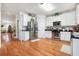 Modern kitchen with white cabinets, stainless steel appliances, and hardwood floors at 2249 Ewell Park Dr, Lawrenceville, GA 30043