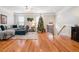 Open living room with hardwood floors, sectional sofa, and Christmas tree at 2249 Ewell Park Dr, Lawrenceville, GA 30043