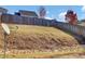 Sloped backyard with retaining wall and satellite dish at 2342 Terrace View Sw Cir, Atlanta, GA 30315