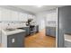 Modern kitchen with gray and white cabinets, stainless steel appliances, and hardwood floors at 3655 Autumn Ridge Pkwy, Marietta, GA 30066