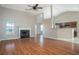 Spacious living room with hardwood floors, a fireplace, and a view of the kitchen at 945 Durham Way, Stockbridge, GA 30281