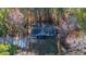 Aerial view of a single-story house on a wooded lot at 157 Reynolds Rd, Bowdon, GA 30108