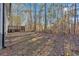 Wooded backyard with a view of the home and deck at 157 Reynolds Rd, Bowdon, GA 30108
