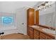 Bathroom boasts double sinks, wood cabinets, and a garden tub at 157 Reynolds Rd, Bowdon, GA 30108