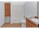 Clean bathroom with a tub, toilet and wood cabinets at 157 Reynolds Rd, Bowdon, GA 30108