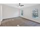 Spacious bedroom with ceiling fan and plush carpeting at 157 Reynolds Rd, Bowdon, GA 30108