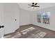 Bright bedroom with large windows, ceiling fan, and plush carpeting at 157 Reynolds Rd, Bowdon, GA 30108