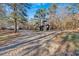 Gravel driveway leading to house and detached shed at 157 Reynolds Rd, Bowdon, GA 30108