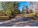 Gravel driveway with tall grass and trees at 157 Reynolds Rd, Bowdon, GA 30108