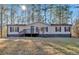Single-story home with deck, large yard, and wooded lot at 157 Reynolds Rd, Bowdon, GA 30108