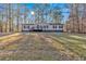Single-story home with deck and large yard, wooded lot at 157 Reynolds Rd, Bowdon, GA 30108