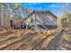 Single-wide home exterior with wooden deck and rock landscaping at 157 Reynolds Rd, Bowdon, GA 30108
