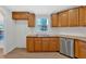 Kitchen with wood cabinets, sink, and dishwasher at 157 Reynolds Rd, Bowdon, GA 30108
