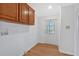 Laundry room with wood cabinets and exterior access at 157 Reynolds Rd, Bowdon, GA 30108