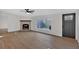 Bright living room with fireplace, window, and hardwood floors at 157 Reynolds Rd, Bowdon, GA 30108