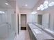 Double vanity bathroom with granite countertop and glass shower at 2005 Ocean Nw Dr, Atlanta, GA 30318