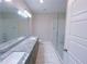 Double vanity bathroom with granite countertop and glass shower at 2005 Ocean Nw Dr, Atlanta, GA 30318