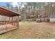 Fenced backyard with playset, storage shed, and wooden deck at 152 Lost Lake Trl, Villa Rica, GA 30180