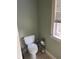 Small bathroom with toilet and window at 8228 River Pointe Overlook, Winston, GA 30187