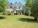 Brick house with a well-maintained lawn at 8228 River Pointe Overlook, Winston, GA 30187