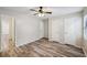 Bright bedroom with ceiling fan, hardwood floors, and ample closet space at 703 Pine Tree Trl, Atlanta, GA 30349