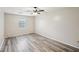 Simple bedroom with wood-look floors and large window at 703 Pine Tree Trl, Atlanta, GA 30349