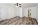 Spacious bedroom with wood-look floors and ceiling fan at 703 Pine Tree Trl, Atlanta, GA 30349