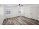 Bright bedroom with wood-look floors and ceiling fan at 703 Pine Tree Trl, Atlanta, GA 30349