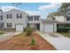Two-story townhome with attached garage and landscaping at 703 Pine Tree Trl, Atlanta, GA 30349