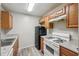 Updated kitchen features modern appliances and wood cabinets at 703 Pine Tree Trl, Atlanta, GA 30349