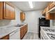 Efficient kitchen with wood cabinets and appliances at 703 Pine Tree Trl, Atlanta, GA 30349