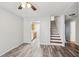 Open living area with hardwood floors, kitchen view and stairs at 703 Pine Tree Trl, Atlanta, GA 30349