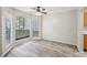 Living room with large windows and ceiling fan at 703 Pine Tree Trl, Atlanta, GA 30349