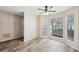 Living room with wood-look floors and access to hallway at 703 Pine Tree Trl, Atlanta, GA 30349